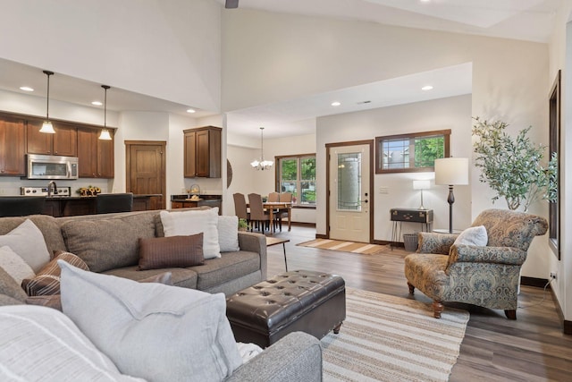 98 Tribute Ave, Hudson, WI 54016 - living area featuring wood finished floors, a chandelier, recessed lighting, and high vaulted ceiling
