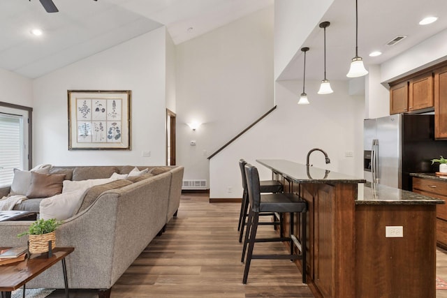 98 Tribute Ave, Hudson, WI 54016 - living area with dark wood-style floors, lofted ceiling, a ceiling fan, recessed lighting, and stairway