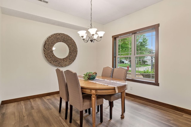 98 Tribute Ave, Hudson, WI 54016 - dining space featuring a chandelier and wood finished floors