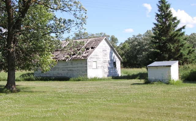 24195 Center St E, Mayfield Twp, MN 56701 - view of green lawn featuring a storage unit