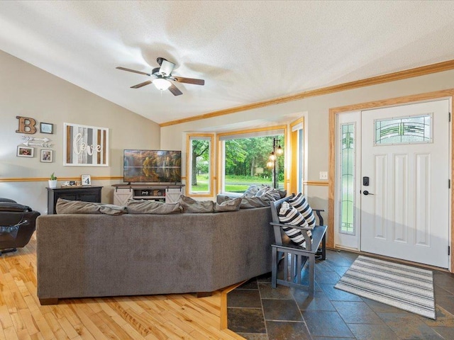 4669 Brentwood Rd, Baxter, MN 56425 - living room featuring lofted ceiling, a ceiling fan, crown molding, and a textured ceiling