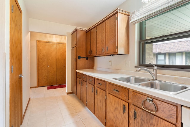 1200 18th Ave NW Unit 132, Austin, MN 55912 - kitchen featuring light countertops, brown cabinetry, and light tile patterned floors