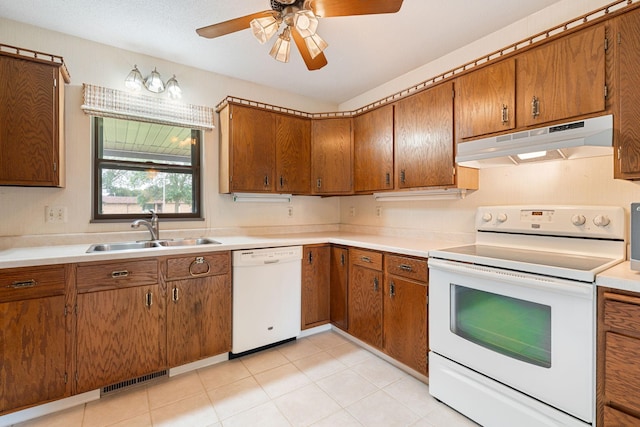 1200 18th Ave NW Unit 132, Austin, MN 55912 - kitchen with white appliances, under cabinet range hood, brown cabinets, and ceiling fan