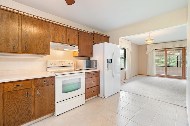 1200 18th Ave NW Unit 132, Austin, MN 55912 - kitchen with white appliances, under cabinet range hood, brown cabinetry, and light carpet