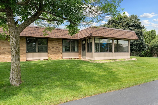 1200 18th Ave NW Unit 132, Austin, MN 55912 - back of house with a lawn, mansard roof, roof with shingles, and brick siding