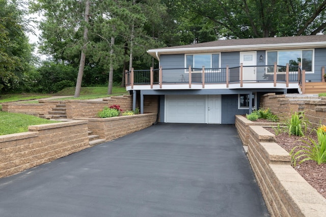 728 Linn St N, Prescott, WI 54021 - view of front of property with asphalt driveway, a garage, and view of scattered trees