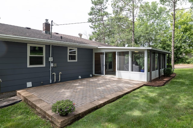 728 Linn St N, Prescott, WI 54021 - rear view of property with a sunroom, a chimney, a patio, and a lawn