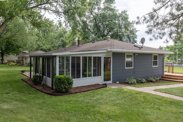 728 Linn St N, Prescott, WI 54021 - rear view of property featuring a sunroom, a lawn, roof with shingles, and a deck