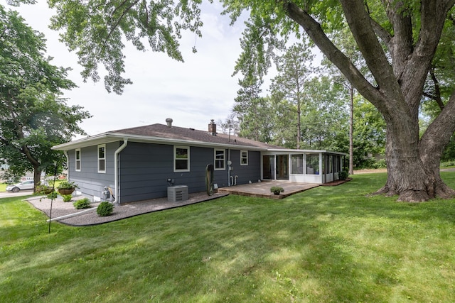 728 Linn St N, Prescott, WI 54021 - back of house featuring a sunroom, a chimney, a yard, and a wooden deck