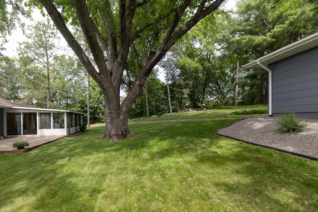 728 Linn St N, Prescott, WI 54021 - view of green lawn featuring a sunroom, view of wooded area, and a patio area