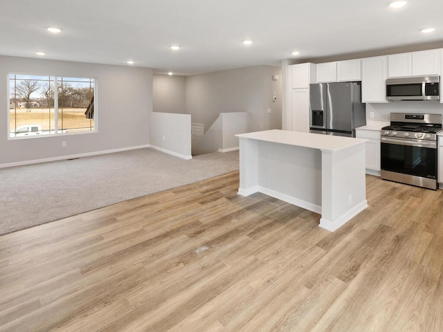 6706 376th St, North Branch, MN 55056 - kitchen featuring appliances with stainless steel finishes, a center island, white cabinetry, recessed lighting, and light countertops
