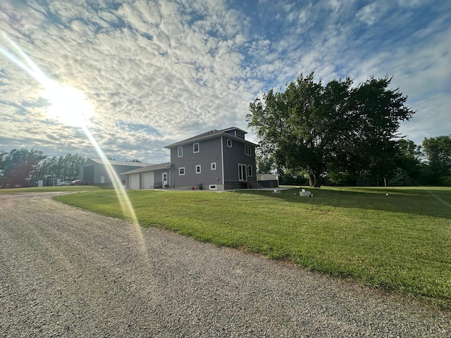1865 180th St, Norman Twp, MN 56220 - view of property exterior with an attached garage, gravel driveway, and a yard