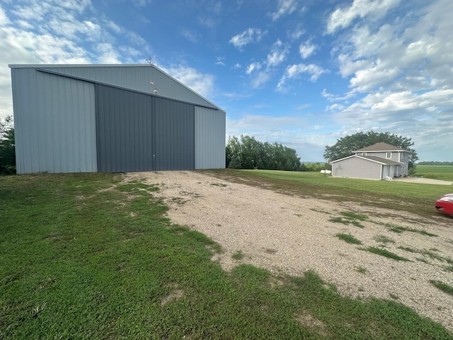 1865 180th St, Norman Twp, MN 56220 - view of pole building featuring a lawn and gravel driveway
