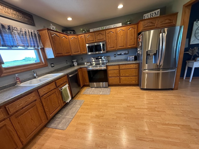 1865 180th St, Norman Twp, MN 56220 - kitchen with stainless steel appliances, brown cabinets, recessed lighting, and light wood finished floors