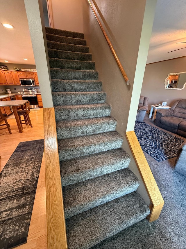 1865 180th St, Norman Twp, MN 56220 - staircase featuring wood finished floors and recessed lighting