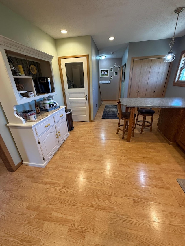 1865 180th St, Norman Twp, MN 56220 - dining area featuring light wood-type flooring and a textured ceiling