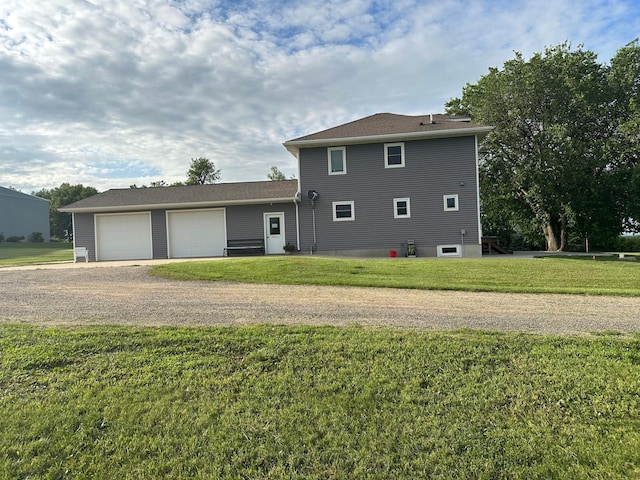 1865 180th St, Norman Twp, MN 56220 - back of house featuring dirt driveway, a yard, and an attached garage