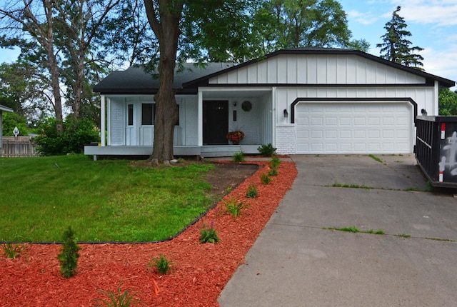10419 Goldenrod St NW, Coon Rapids, MN 55448 - view of front of property featuring a garage, driveway, a front lawn, and brick siding