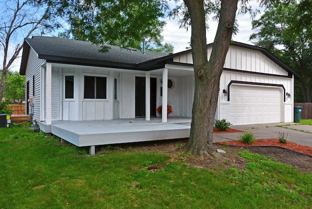 10419 Goldenrod St NW, Coon Rapids, MN 55448 - view of front of house with a porch, board and batten siding, an attached garage, driveway, and a front lawn