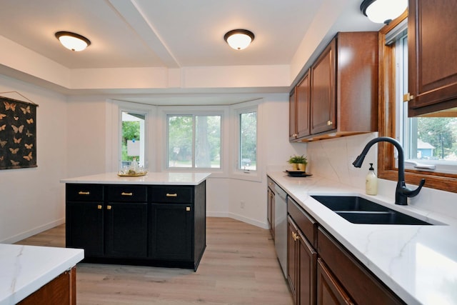 10419 Goldenrod St NW, Coon Rapids, MN 55448 - kitchen with light wood-type flooring, dishwasher, light stone counters, dark cabinetry, and brown cabinetry