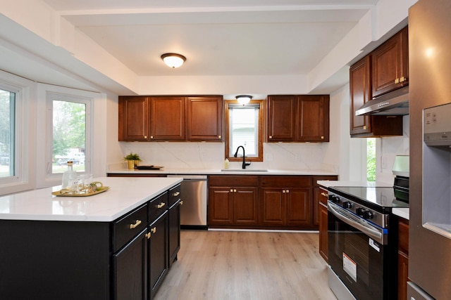10419 Goldenrod St NW, Coon Rapids, MN 55448 - kitchen with stainless steel appliances, under cabinet range hood, and plenty of natural light