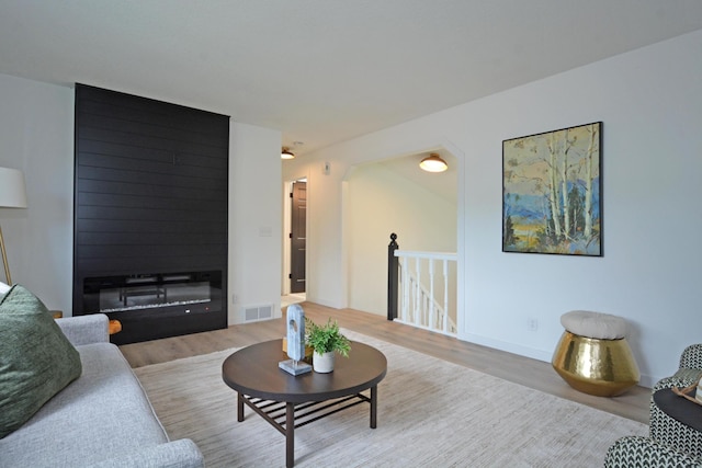 10419 Goldenrod St NW, Coon Rapids, MN 55448 - living area featuring wood finished floors and a large fireplace