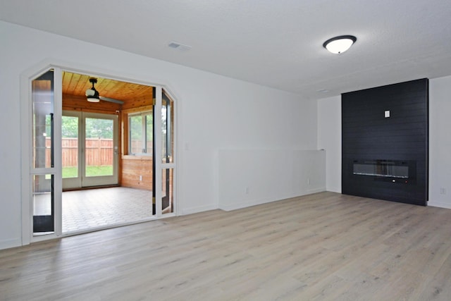 10419 Goldenrod St NW, Coon Rapids, MN 55448 - unfurnished living room featuring wood finished floors, a large fireplace, and a ceiling fan
