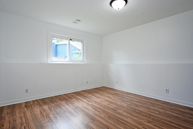 10419 Goldenrod St NW, Coon Rapids, MN 55448 - spare room featuring dark wood-style flooring