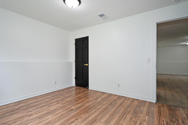 10419 Goldenrod St NW, Coon Rapids, MN 55448 - spare room with wood finished floors and baseboards