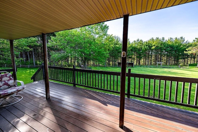 N5172 County Road O, Atlanta Twp, WI 54819 - wooden deck featuring a lawn and view of wooded area