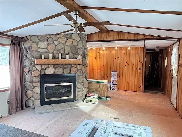 N5172 County Road O, Atlanta Twp, WI 54819 - unfurnished living room with ceiling fan, a stone fireplace, and wooden walls
