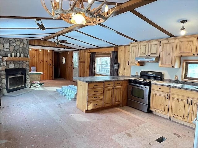 N5172 County Road O, Atlanta Twp, WI 54819 - kitchen featuring stainless steel gas range oven, under cabinet range hood, dark countertops, a peninsula, and open floor plan