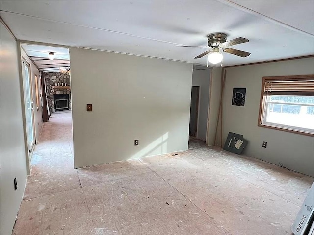 N5172 County Road O, Atlanta Twp, WI 54819 - unfurnished room with a stone fireplace and a ceiling fan