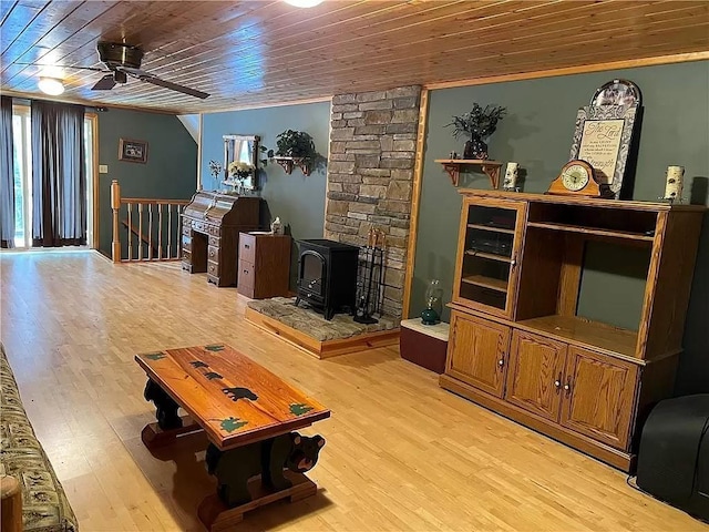 N5172 County Road O, Atlanta Twp, WI 54819 - living area with a wood stove, ceiling fan, wood ceiling, light wood finished floors, and ornamental molding