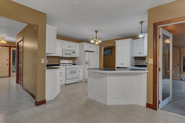 213 2nd St N, Cold Spring, MN 56320 - kitchen with white appliances, a peninsula, a chandelier, and white cabinets
