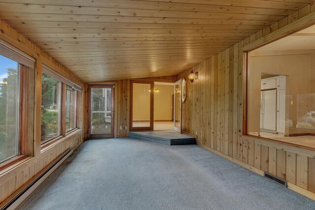 213 2nd St N, Cold Spring, MN 56320 - unfurnished sunroom featuring a baseboard heating unit, healthy amount of natural light, lofted ceiling, wooden walls, and carpet floors
