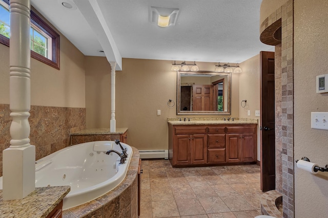 213 2nd St N, Cold Spring, MN 56320 - full bath with a baseboard radiator, double vanity, a tub with jets, and a textured ceiling