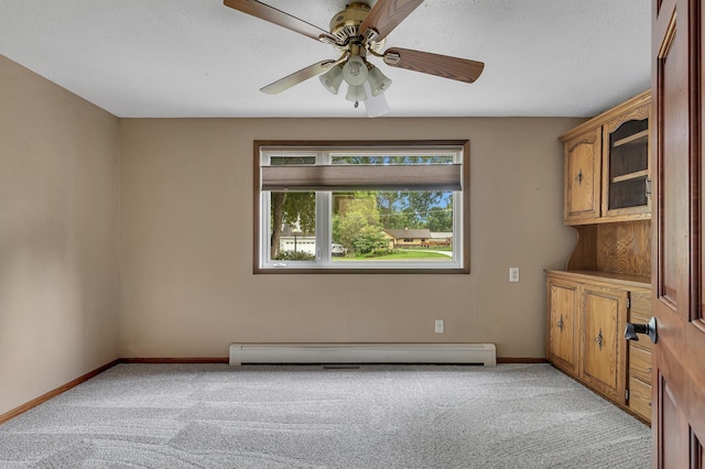 213 2nd St N, Cold Spring, MN 56320 - unfurnished room featuring light carpet, baseboard heating, and a ceiling fan