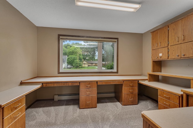 213 2nd St N, Cold Spring, MN 56320 - unfurnished office with built in desk, light colored carpet, and a baseboard radiator