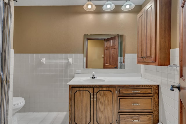 213 2nd St N, Cold Spring, MN 56320 - bathroom with tile walls, vanity, and wainscoting