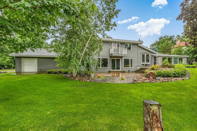 213 2nd St N, Cold Spring, MN 56320 - rear view of house with a balcony, a lawn, a garage, and a patio area