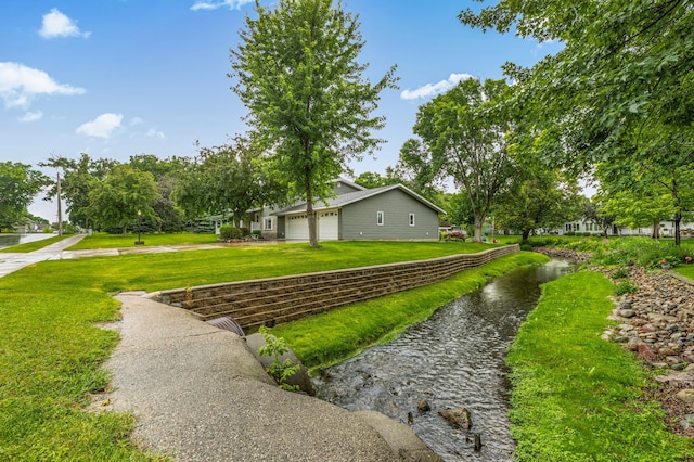 213 2nd St N, Cold Spring, MN 56320 - view of green lawn featuring driveway and an attached garage