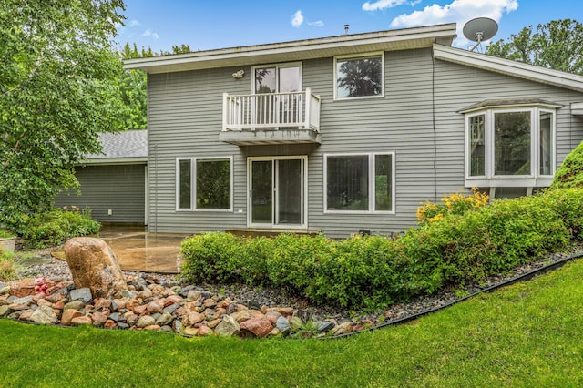 213 2nd St N, Cold Spring, MN 56320 - back of house with a balcony, a patio area, and a lawn