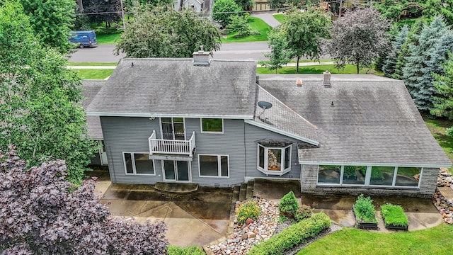 213 2nd St N, Cold Spring, MN 56320 - back of property featuring a patio area, roof with shingles, a balcony, and a chimney