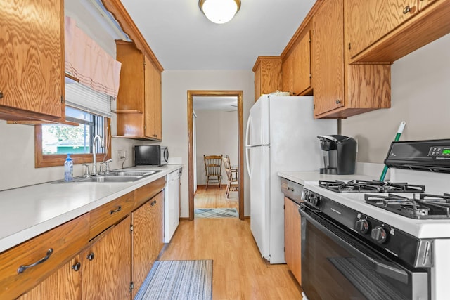 5913 Zenith Ave N, Brooklyn Center, MN 55429 - kitchen featuring black appliances, light wood-type flooring, light countertops, and brown cabinets