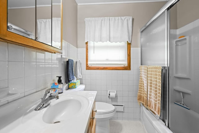 5913 Zenith Ave N, Brooklyn Center, MN 55429 - bathroom with tile walls, vanity, bath / shower combo with glass door, and tile patterned floors