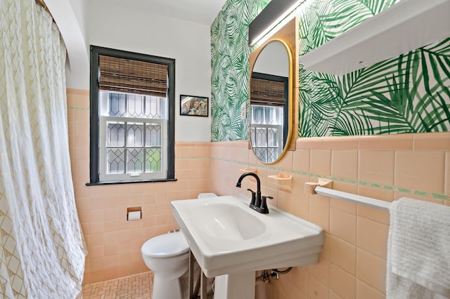 704 58th St, Minneapolis, MN 55417 - full bathroom with wainscoting, tile walls, plenty of natural light, and a shower with shower curtain
