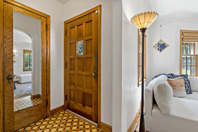 704 58th St, Minneapolis, MN 55417 - entryway featuring healthy amount of natural light, arched walkways, and tile patterned floors