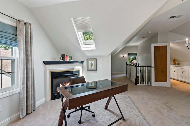704 58th St, Minneapolis, MN 55417 - home office featuring light carpet, a skylight, lofted ceiling, and a glass covered fireplace