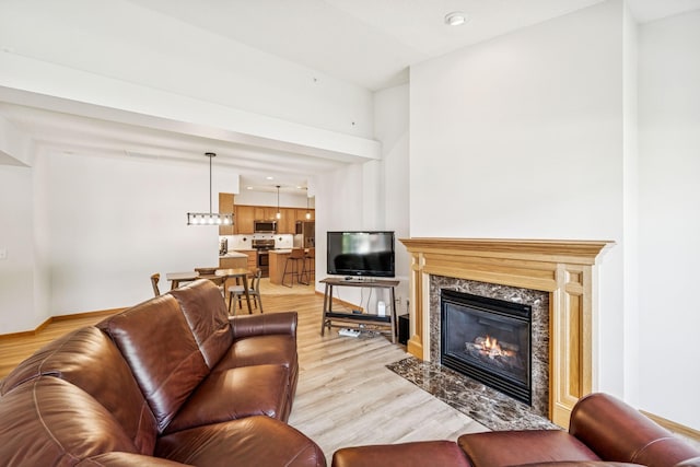 13936 54th Ave N Unit 2, Plymouth, MN 55446 - living room featuring light wood finished floors, a high end fireplace, and recessed lighting